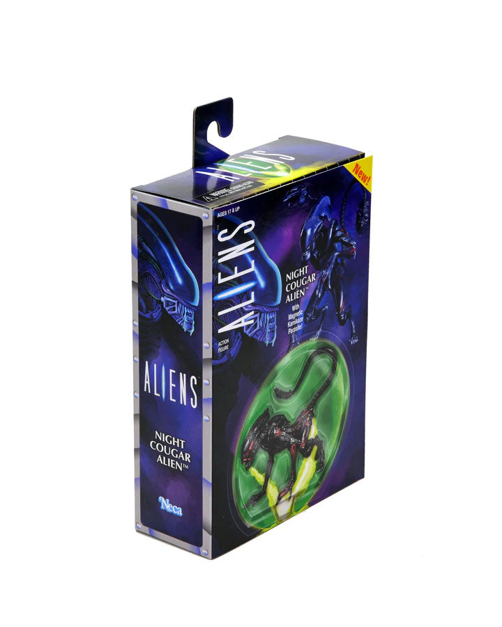 Boxed toy figure of an alien with glowing effects on a white background