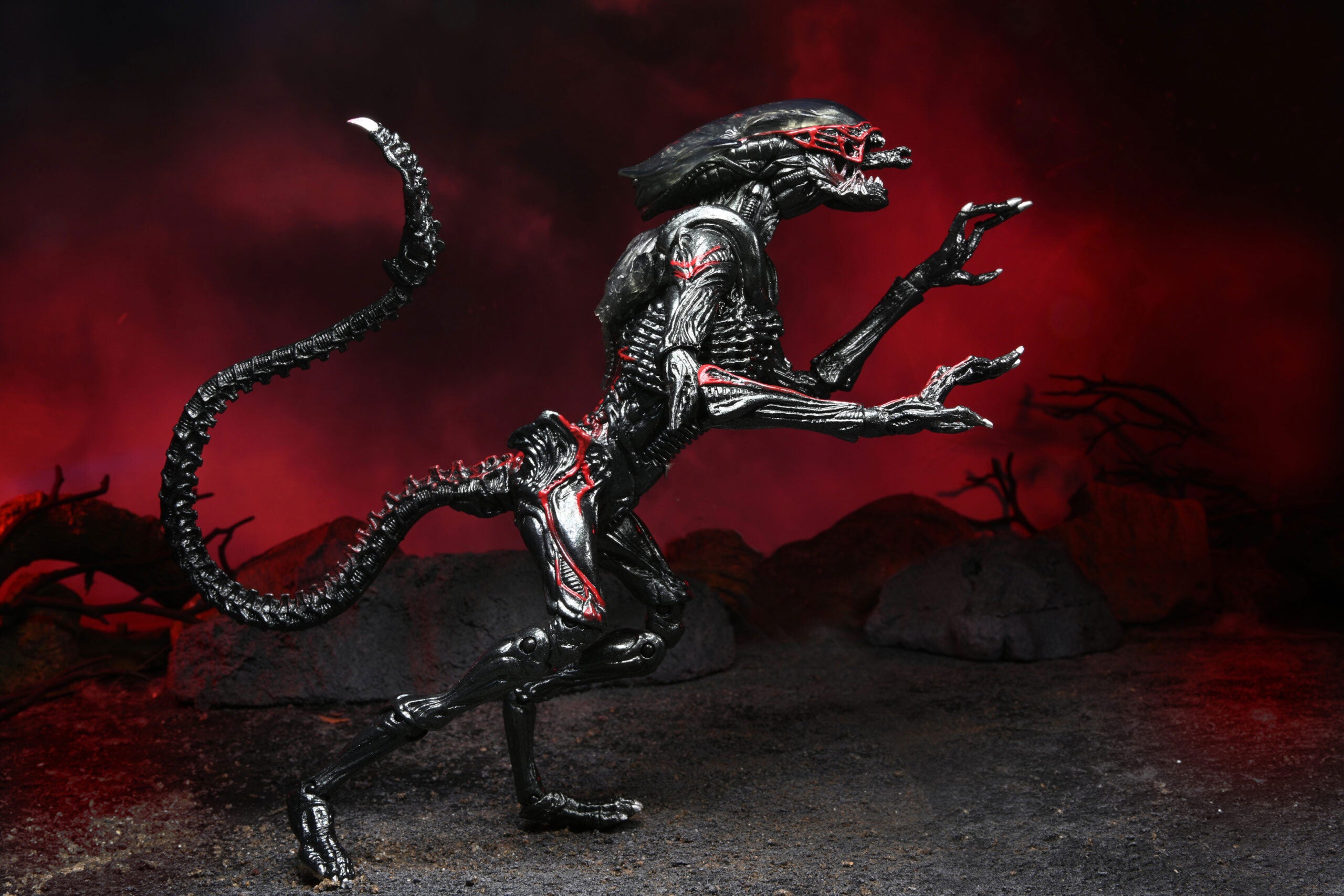 Alien-like creature figurine with a dark, ominous background