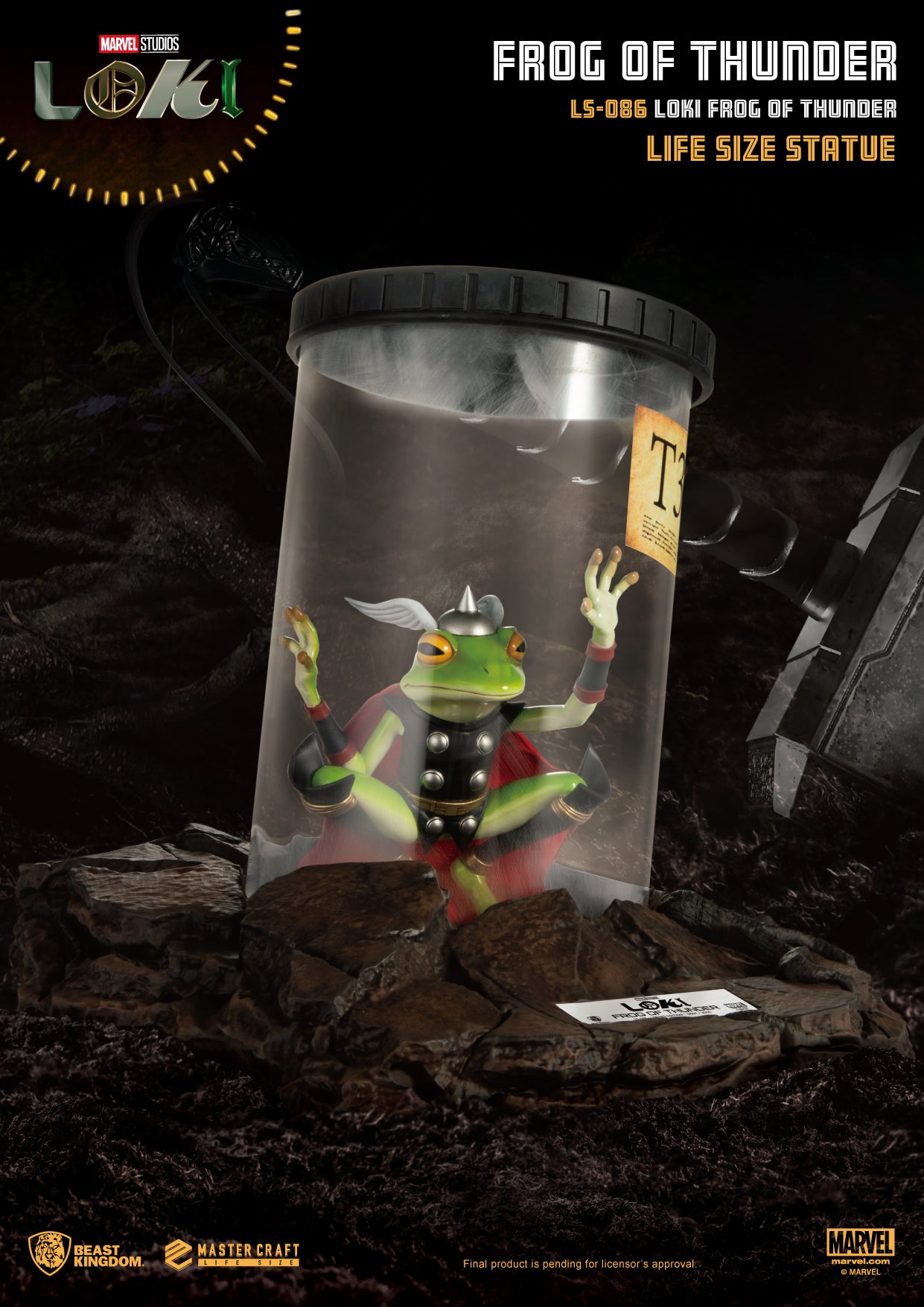 Life size statue of Loki transformed into a frog, placed inside a glass jar with the label T365, set against a rocky backdrop.