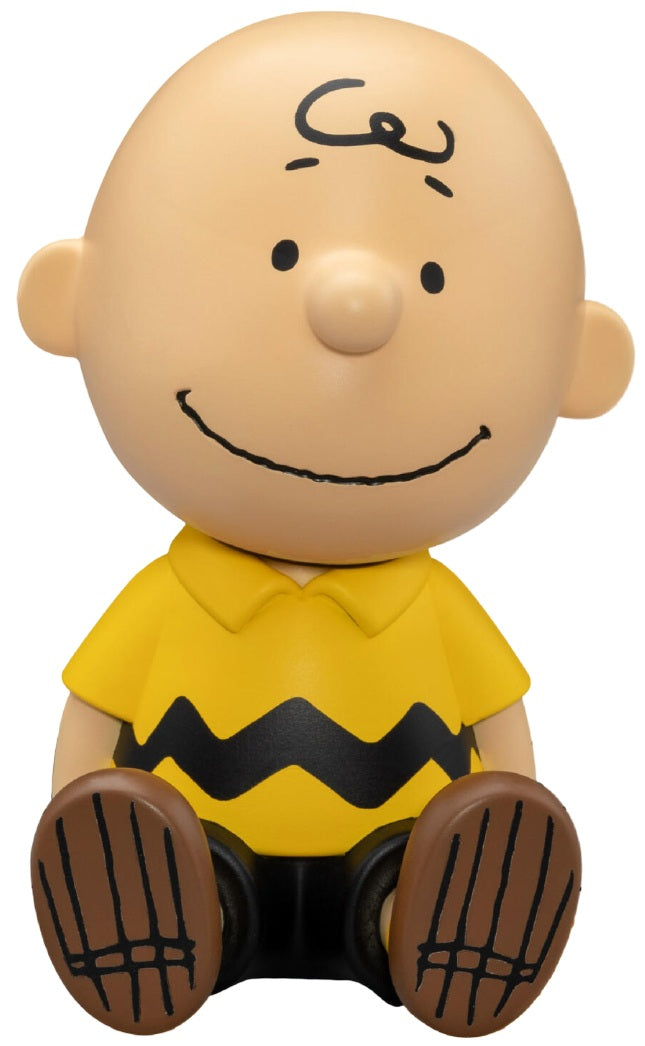 Charlie Brown figure with a yellow shirt and brown shoes on a white background. Beast Kingdom Piggy Bank Peanuts Series Palm Size Vinyl Functional Figurine Charlie Brown.