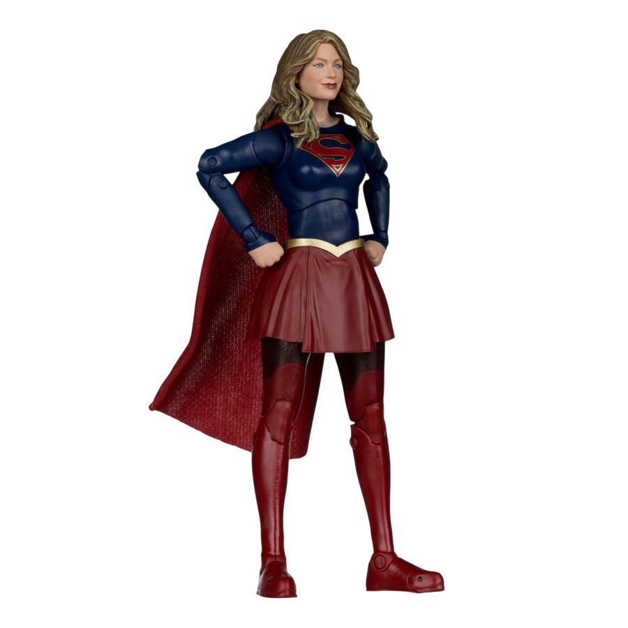 Supergirl action figure in blue and red costume on a white background