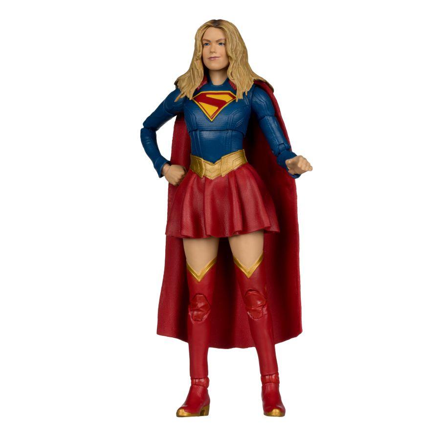 Supergirl action figure in blue and red costume with cape on a white background
