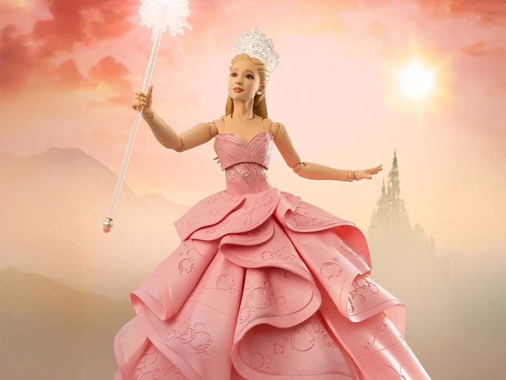 Glinda Action figure holding wand, with Emerald city in the background. 