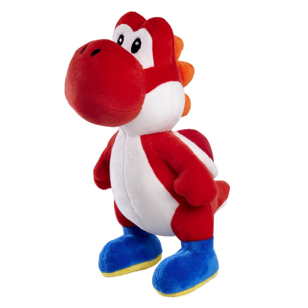 Image shows Red Yoshi plushie sitting up on it's hind legs. 